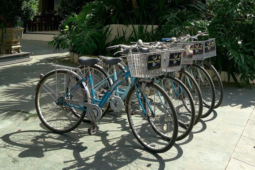 Banana Garden branded bicycles parked under yellow lanterns