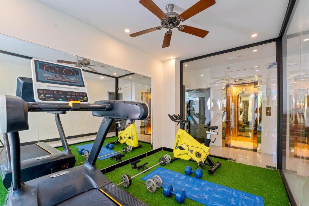 Small fitness room with treadmill, spin bikes and free weights