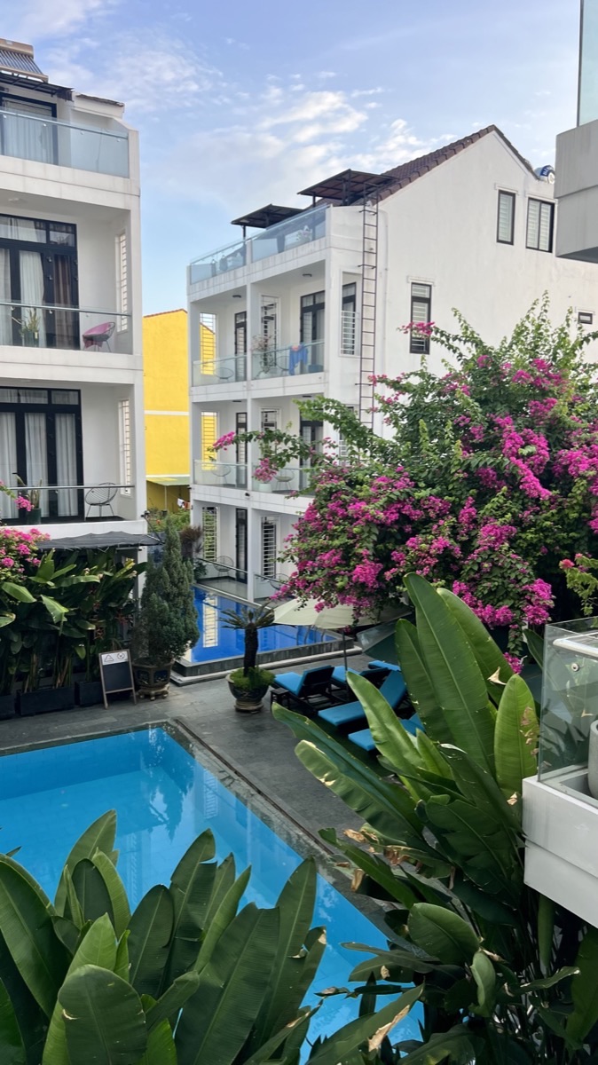Bougainvillea cascading over the pool between the buildings