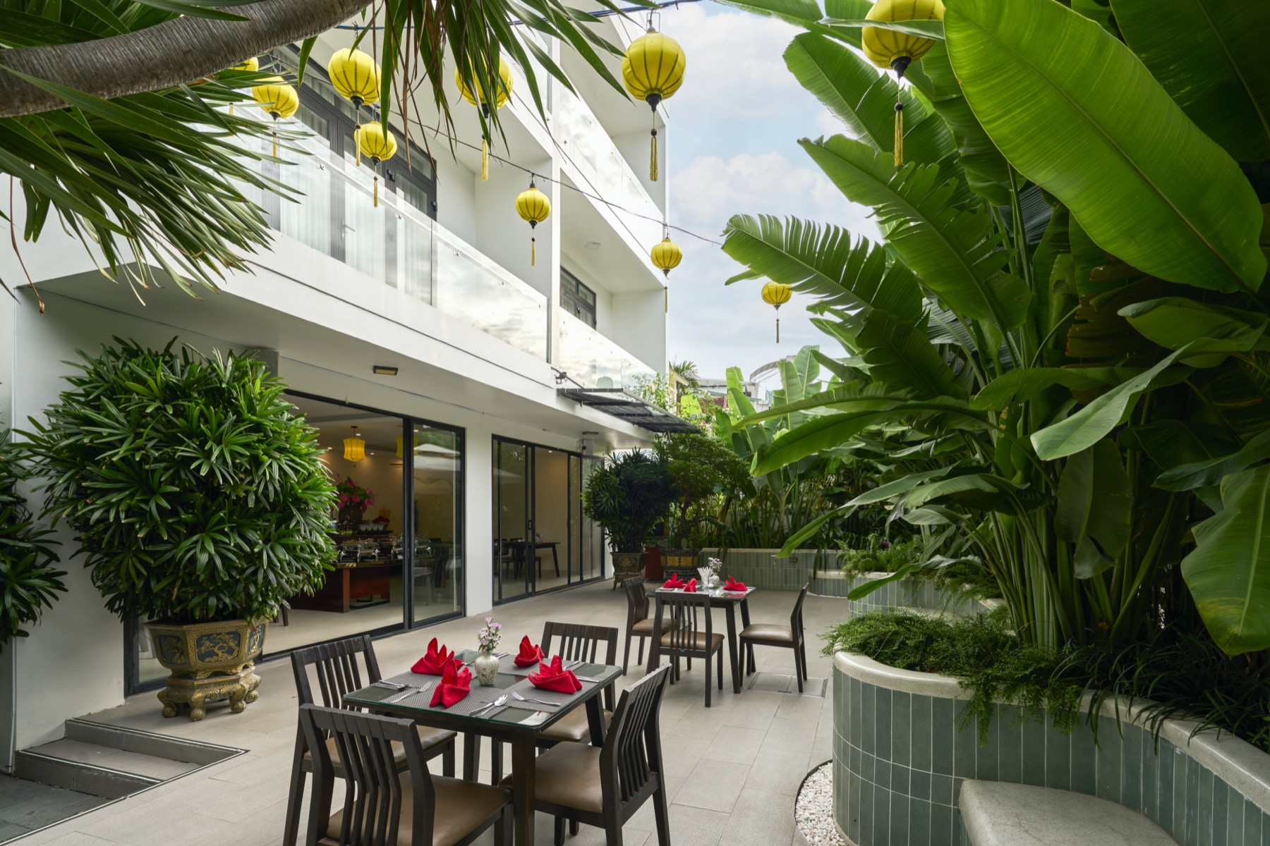 Garden dining courtyard strung with yellow lanterns