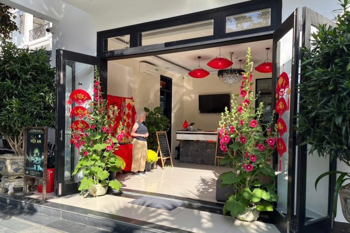 A guest in the lobby entrance decorated for Tet