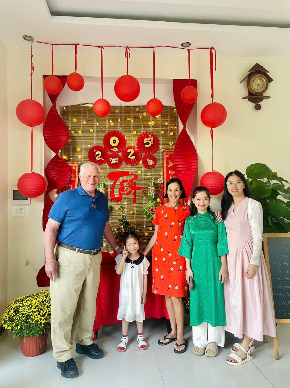 A guest family posing with staff at the Lunar New Year display