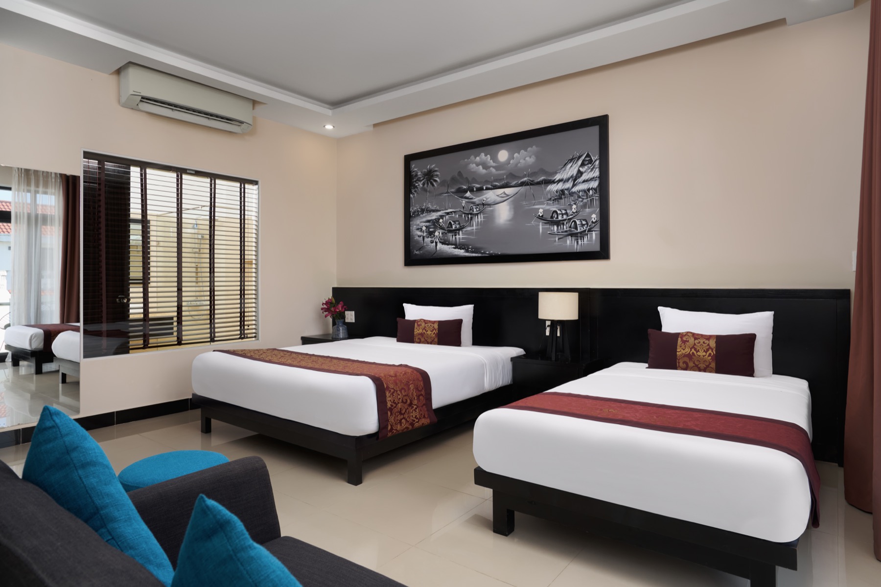 Deluxe Double/Twin room with a teal armchair and private balcony